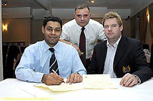 Mohammad Zaman signs watched by Crompton’s Glenn Dawson and Andrew Kershaw. Mohammad Zaman signs watched by Crompton’s Glenn Dawson and Andrew Kershaw.