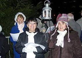 SWITCH ON . . . carol singers, front left Eileen Finch and Tracy Kayley with the St Margaret’s Church Choir 
