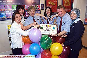 ALL smiles . . . staff celebrate the bank’s 125th anniversary 