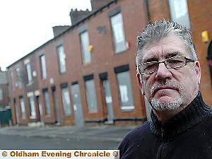 GHOST town . . . Peter Hibberd outside the “tinned-up” houses in Derker GHOST town . . . Peter Hibberd outside the “tinned-up” houses in Derker