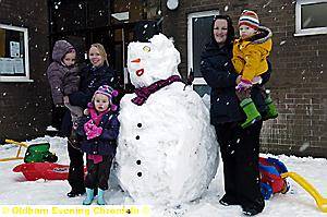 TODDLERS HAVE FUN . . . The Pies pre-school in Waterhead with their snowman. From left: Hannah Barratt-Maher (three), Debbie Williams, Ruby Coates (four), Kati Fitzgerald and two-year-old Elijah Pomfrey 