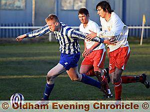 Oldham Town’s Darren Scanlan (left) takes on the Blackpool defence in Saturday’s 2-0 win at the Whitebank Stadium. Picture by TIM FRANCE. 