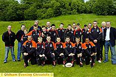 Higginshaw Eagles under-13s players, coaches, committee and sponsors line up before their tour to France. 