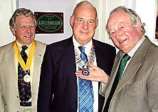 ALL yours . . . Peter Mallinson (right) hands over the presidential chain to Stan Bowes (centre) while Rob Knotts, president-elect, looks on 
