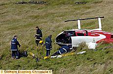 Firefighters handle debris from the crashed chopper 