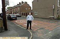 ROAD WORTHY. . .Councillor Ian Barker on an area needing attention in Failsworth West 