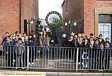 WOW! . . . pictured outside the stunning new gates are Broadfield School pupils with Anne Gilligan from Green Monsters 
