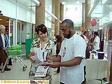 CONNECTING with the community . . . Afruz Miah speaks to a shopper CONNECTING with the community . . . Afruz Miah speaks to a shopper