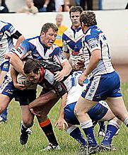 ON THE DRIVE: Oldham’s Chris Baines (above) charges his way through the Workington tackles. 