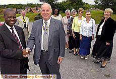 HAND of friendship . . . High Commissioner George Liswaniso (left) and Stan Bowes, president of Saddleworth Rotary Club