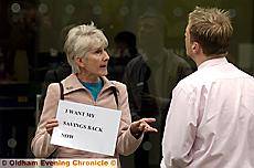 LINDA GRIME speaks to a member of staff during her one-woman protest outside the Bradford and Bingley branch in High Street, Oldham. 