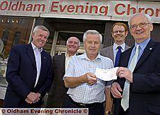 Chronicle editor Jim Williams (extreme right) is pictured presenting a cheque for £2,200 to Malcolm Hill of Saddleworth Rotary Club with (from the left) Gordon Russell and Brian Fort, both of Rotary Club of Oldham Metro, and Steve Duthie, circulation manager of the Chronicle. Chronicle editor Jim Williams (extreme right) is pictured presenting a cheque for £2,200 to Malcolm Hill of Saddleworth Rotary Club with (from the left) Gordon Russell and Brian Fort, both of Rotary Club of Oldham Metro, and Steve Duthie, circulation manager of the Chronicle.
