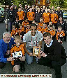 handover: AFC Oldham 2005 secretary Bob Rowlandson (left) and player Curtis Murphy receive the FA Charter Standard Award from Stockport County striker Matthew McNeill and Andy Basterfield, of the Manchester County FA. handover: AFC Oldham 2005 secretary Bob Rowlandson (left) and player Curtis Murphy receive the FA Charter Standard Award from Stockport County striker Matthew McNeill and Andy Basterfield, of the Manchester County FA.
