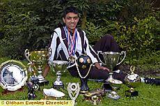 SILVER service . . . Mohammed shows off some of his trophies SILVER service . . . Mohammed shows off some of his trophies