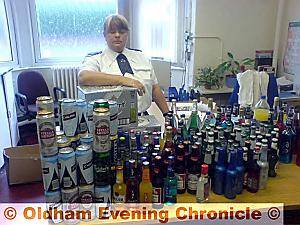 PCSO Barbara Pearson with some of the seized alcohol PCSO Barbara Pearson with some of the seized alcohol