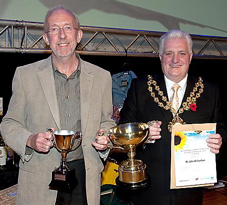 JOHN Richardson won the Chronicle Cup for his allotment in Heyside. It was received on his behalf by David Tempest, a colleague at Heyside, pictured with the Mayor of Oldham, Councillor Jim McArdle 