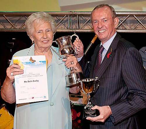 BEST FCHO Garden winner . . . Sheila Cronley, of Beech Avenue, Greenfield, receives her trophy from Clive Newton of main sponsors Emanuel Whitaker 