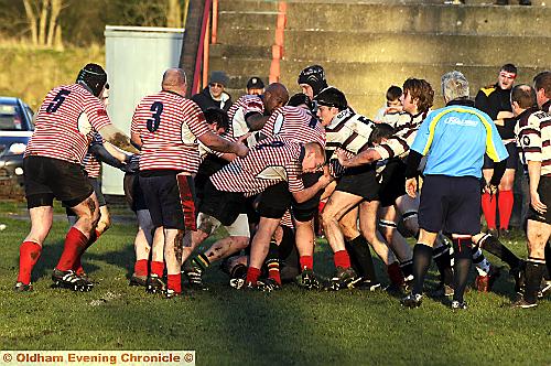 GET STUCK IN: Oldham’s A team pack (red and white) put pressure on Bowden. GET STUCK IN: Oldham’s A team pack (red and white) put pressure on Bowden.