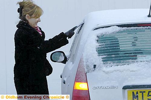 COLD start . . . Dawn Hilditch scrapes snow and ice from her car in Castleton Road 