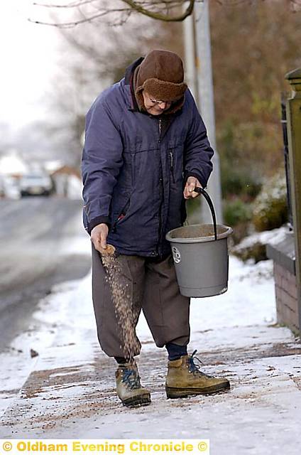 TRUE grit . . . Dennis Naylor salts the pavement outside Gravelhole Methodist Church in Thornham 