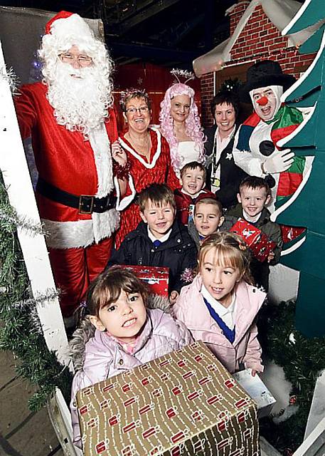 Angela Carus (second from right), of Home Delivery network, and staff from the Shaw centre with children from Buckstones Primary School. 