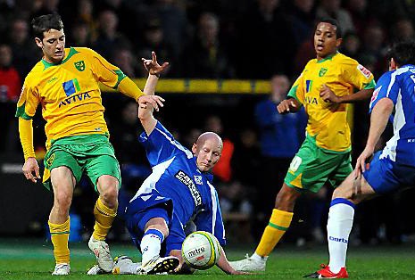 GROUNDED: Athletic midfielder Danny Whitaker  comes under pressure from Wes Hoolahan, who scored Norwich City’s second goal.