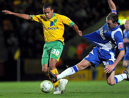 HOLD ON TIGHT: Dale Stephens slides in to challenge Norwich City’s Korey Smith. 