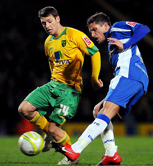 Athletic defender Paul Black clears from Wes Hoolahan. 