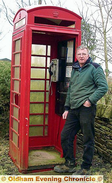 FALLING TO PIECES . . . Michael Fancy with the telephone box before its recent restoration. FALLING TO PIECES . . . Michael Fancy with the telephone box before its recent restoration.