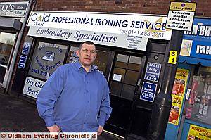 DOUBLE trouble . . . William Bowles outside his shop and the signs which he says are costing him business DOUBLE trouble . . . William Bowles outside his shop and the signs which he says are costing him business