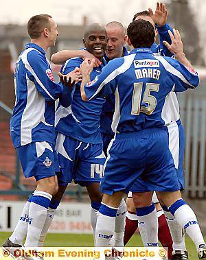 EVERYBODY HAPPY: Reuben Hazell is mobbed by his delighted team-mates after his eighth-minute header had given his side the lead. 