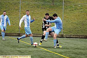 CENTRE OF ATTENTION: Shaun Renshaw (centre), of Limeside Athletic, battles for the ball with Steven Caine FC’s Clayton Palmer (right). 