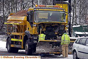 Workmen fix a broken-down gritter in Chew Valley Road, Greenfield 