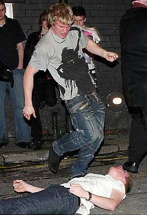 SICKENING . . . a man is kicked in the head as he lies on the pavement 