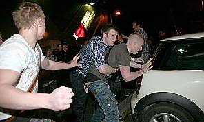DRUNKEN fight . . . a reveller wades in 