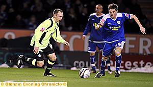ACTION MAN . . . Athletic’s midfield dynamo Mark Allott drives his team forward. 