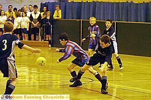 ON the ball . . . players from St Joseph’s School and Holy Trinity, Dobcross, in action 
