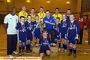 WINNERS . . . St Joseph's team captain James Forde receives the winning trophy from Latics player Dale Stephens