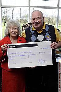 Jim Eyers hands over the cheque to Pat Whiteside, charities manager for Pendlebury and Booth Hall hospitals.