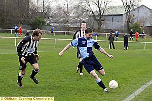 I’M WATCHING YOU: Rick Massey of Chaddertonians clears the ball as an Old Boltonians player puts him under pressure. 