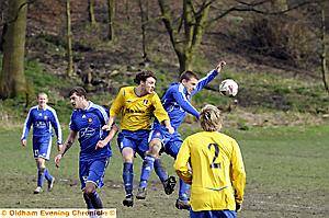 UP AND AT’EM: Diggle’s Tom Matley (right) and Alex Pearson, of Britannia Sports, jump to it in the Huddersfield and District League clash. 