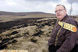Landlord of the Rams Head Inn, Denshaw Geoff Haigh with part of the burnt moor above his pub 
