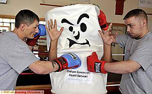 Boxers from Oldham Boxing and Personal Development Centre (who both smoke) put the message across — coach Charlie Henson (left) and Daniel Brophy. 