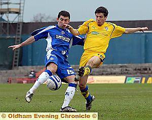 Kevin Maher clears from Colchester’s Alan Maybury. 