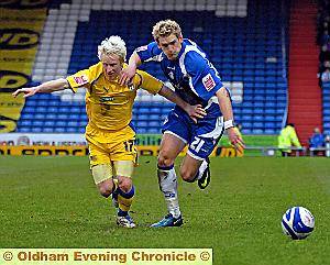 Athletic full-back Daniel Jones attempts to hold off David Perkins. 