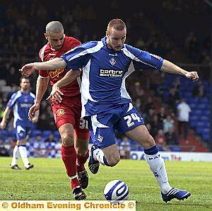 ATHLETIC striker Deane Smalley holds off Crewe left-back Marlon Broomes.