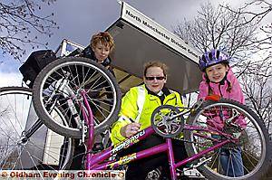 HANDY advice . . . PSCO Sarah Ward security marking bicycles belonging to Sharon Emmott (left) and daughter Kate Emmott 