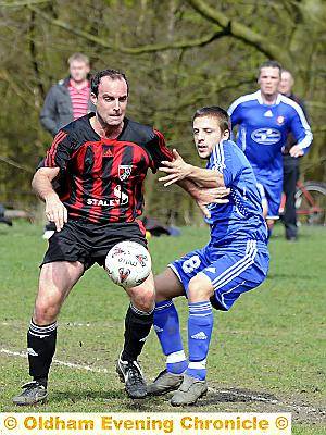 BALL-WINNER: Uppermill’s Mike Nelson (left) holds off Tom Matley.