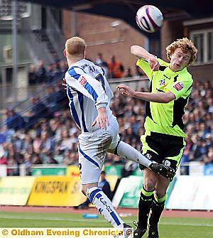 UP AND AT’EM: Athletic’s Chris Taylor (right) and Andrew Whing, of Brighton, duel for a high ball in Saturday’s Coca-Cola League One clash. 
