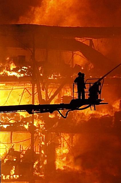 FIrefighters silhouetted dramatically against the Maple Mill wall of fire. Picture by reader Lisa Marks 